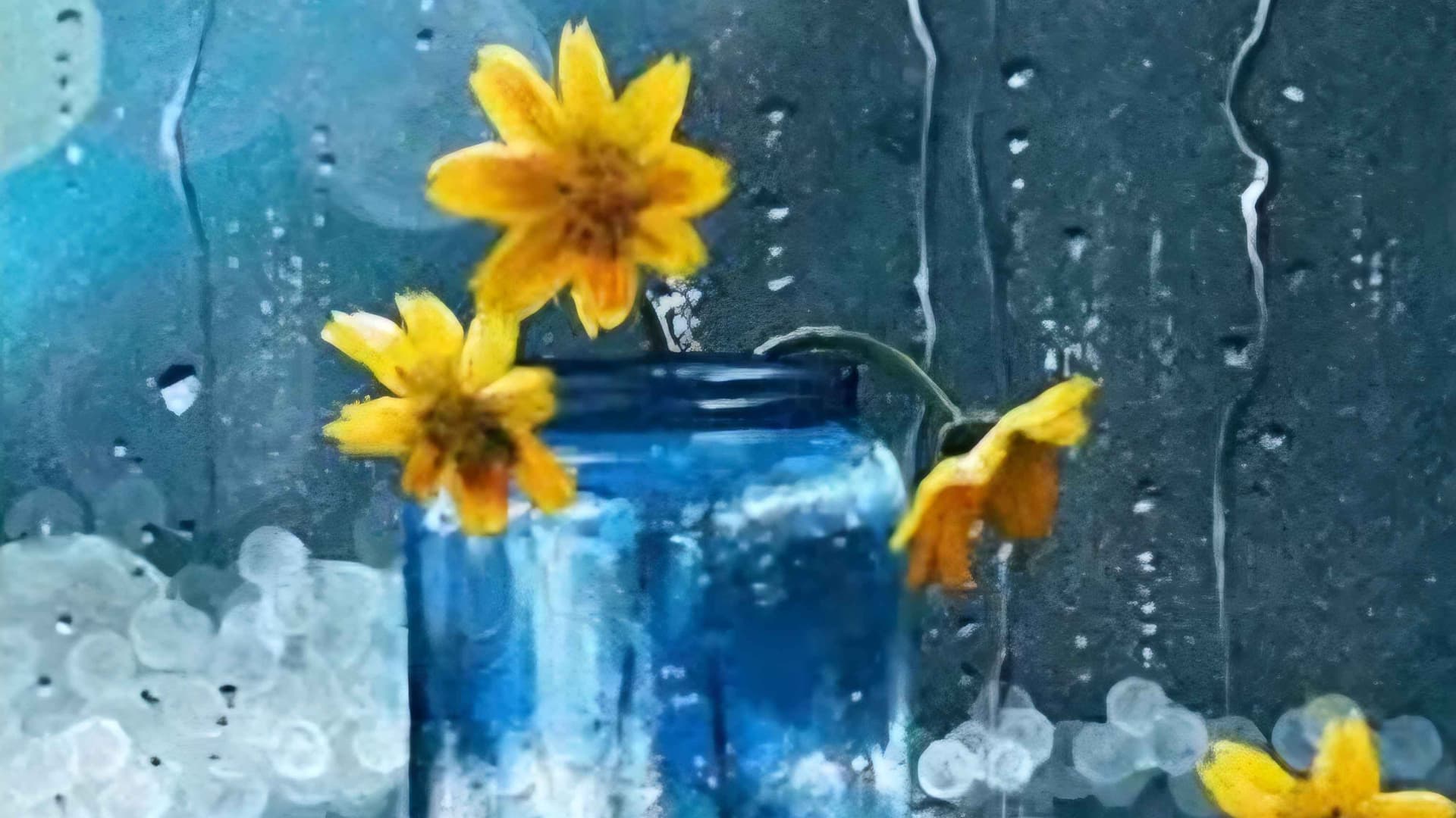 A blue vase with yellow flowers on a window sill. A winter storm in the background the window is lashed with cold rain