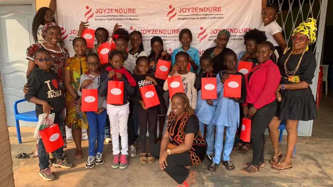 We have warriors (Persons living with sickle cell from 10 years and over, gather for a group picture after a successful launch of our empowerment program (WEP) most are standing with branded gift bags with routine daily medications and mini hot flask