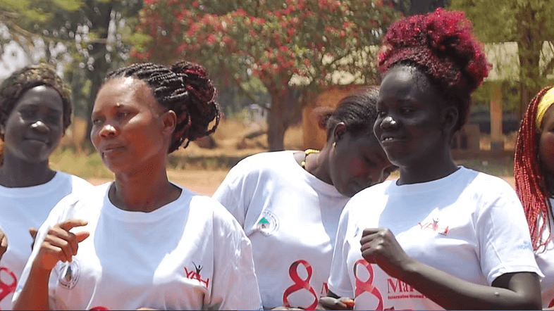 women from the community celebrating the international women's day, happily singing and dance in hope for peace. 