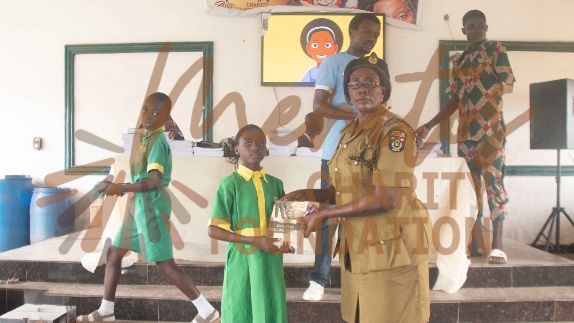 DCN Fatima Dauda presenting supplies to a beneficiary at Back To School 2023