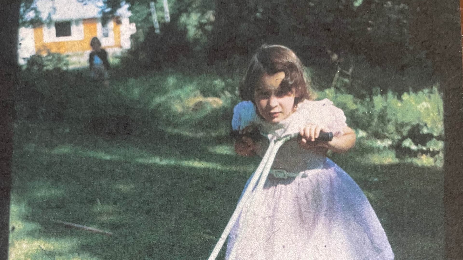 Me at age 10 grabbing the lawnmower to break the idea that girls don't do manual work